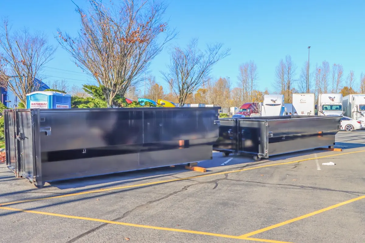 Professional dumpster rental service with roll-off container on residential driveway in North Fayette